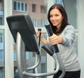 Woman doing exercise on a elliptical trainer