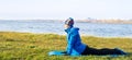 Woman doing exercise in outdoor workout in warm clothes