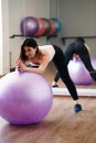 Woman doing exercise using sporting ball in gym Royalty Free Stock Photo