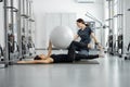 Woman doing exercises with fitness ball with rehabilitation specialist at the gym Royalty Free Stock Photo