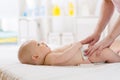 Woman doing exercises and massage baby weared in diaper Royalty Free Stock Photo