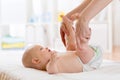 Woman doing exercises and massage baby weared in nappy Royalty Free Stock Photo