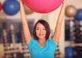 Woman doing exercises with pink fit ball in fitness gym class. Fitness ball helps women get a toned, tight stomach and strong core Royalty Free Stock Photo