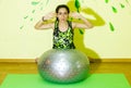 Woman doing fitness exercise, young woman doing fitness exercises with fitness ball in fitness club Royalty Free Stock Photo