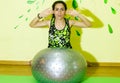 Woman doing fitness exercise, young woman doing fitness exercises with fitness ball in fitness club Royalty Free Stock Photo