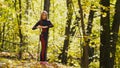 Woman doing fitness exercises outdoor. Female stretching in autumn forest. Slim girl at workout Royalty Free Stock Photo