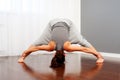 Woman doing flexibility exercise in room