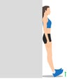 Woman doing foot flex shin exercise leaning against wall