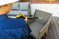 Woman doing garden terrace furniture cleaning with high pressure washer Royalty Free Stock Photo