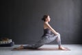 Woman doing Hatha yoga asana Anjaneyasana or low crescent lunge pose isolated,