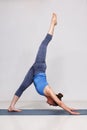 Woman doing Hatha yoga Eka pada adhomukha svanasana Royalty Free Stock Photo