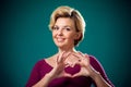 Woman doing heart gesture with fingers. People,lifestyle and emo