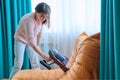 Woman doing house cleaning with vacuum cleaner Royalty Free Stock Photo