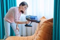 Woman doing house cleaning with vacuum cleaner Royalty Free Stock Photo