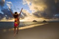 Woman doing hula at sunrise at lanikai