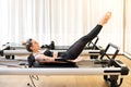 Woman doing the hundred pilates exercise on reformer bed Royalty Free Stock Photo