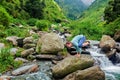 Woman doing Kakasana asana arm balance outdoors