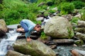 Woman doing Kakasana asana arm balance outdoors