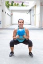 Woman doing the kettlebell squat for muscle strengthening exercise Royalty Free Stock Photo