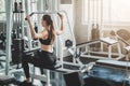 Woman doing lat pull pull down exercise in fitness gym