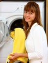 Woman doing laundry with smile