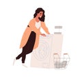 Woman doing laundry in washing machine. Person turning on washer for clothes laundering. Female and housework, lifestyle