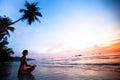 Woman doing lotus yoga pose on the beach Royalty Free Stock Photo