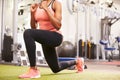 Woman doing lunges in a gym, crop