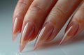 Woman doing a manicure with a nail file on a white background, a closeup of hands and nails, perfect handmodel, perfect Royalty Free Stock Photo