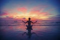 Woman doing meditation near the ocean beach. Royalty Free Stock Photo