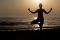 Woman Doing Meditation Near Ocean Beach Yoga Silhouette Royalty Free Stock Photo