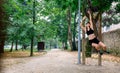 Woman doing monkey exercises on rings Royalty Free Stock Photo