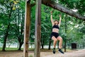 Woman doing monkey exercises on rings Royalty Free Stock Photo