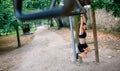 Woman doing monkey exercises on rings Royalty Free Stock Photo