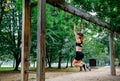 Woman doing monkey exercises on rings Royalty Free Stock Photo