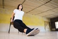 Woman doing physical exercise leaning on chair Royalty Free Stock Photo