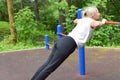 Woman doing physical exercise in a public park in summer outdoor, Royalty Free Stock Photo