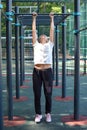 Woman doing physical exercise in a public park in summer outdoor, Royalty Free Stock Photo