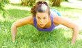 Woman Doing Push Ups In Park