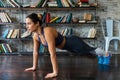 Woman doing push ups workout during fitness training on floor at home