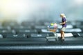 A woman doing safe solo shopping. Miniature people figurines toys conceptual photography