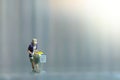 A woman doing safe solo shopping at supermarket wearing a face mask. Miniature people figurines toys conceptual photography