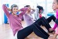 Woman doing sit ups with friends at fitness studio Royalty Free Stock Photo