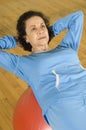 Woman Doing Sit-Ups On A Pilates Ball Royalty Free Stock Photo