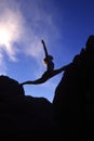 Woman doing splits on a mountaintop