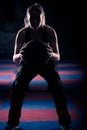 A woman doing a squat with her medicine ball. Royalty Free Stock Photo