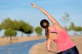 Woman doing stretching exercise for back, sport background. Royalty Free Stock Photo