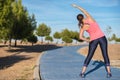 Woman doing stretching exercise for back, sport background. Royalty Free Stock Photo