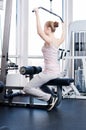 Woman doing stretching exercise at the gym