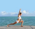 Woman doing stretching exercises by the sea Royalty Free Stock Photo